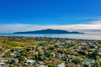 Aerial view of Kāpiti Coast with Kapiti Island in the background.